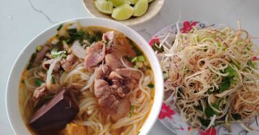 A bowl of Bún Bò Huế, a tasty local food in Hue.