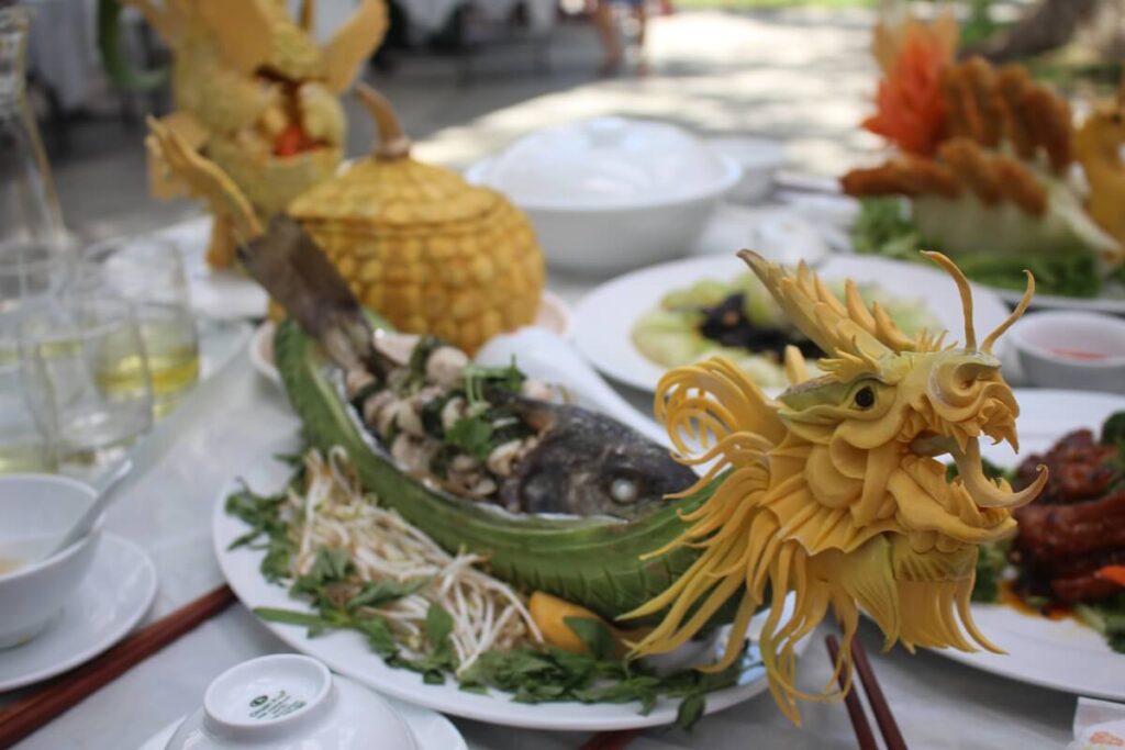 Intricately carved dragon-shaped garnish on a fine dining dish showcasing Hue’s culinary artistry