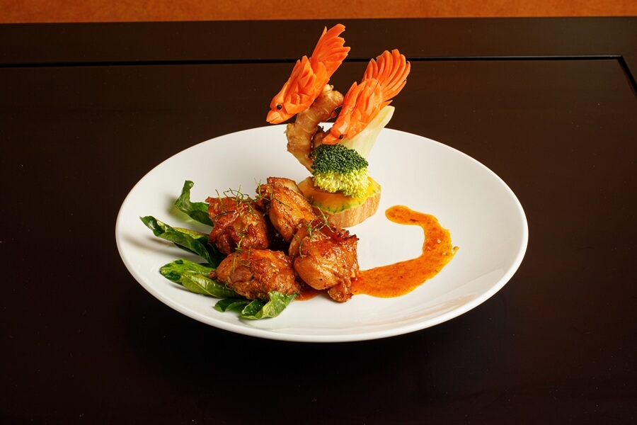 Beautiful dish braised chicken with lemon leaves, decorated with carot fishes
