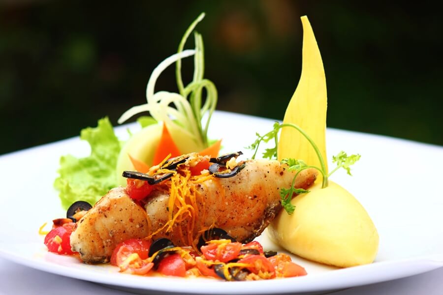 Golden seared fish fillet on a plate
