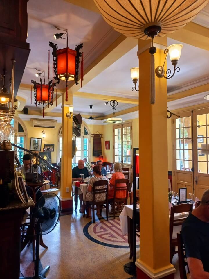 Cozy dining space of Le Jardin de La Carambole Restaurant with guests enjoying their meals