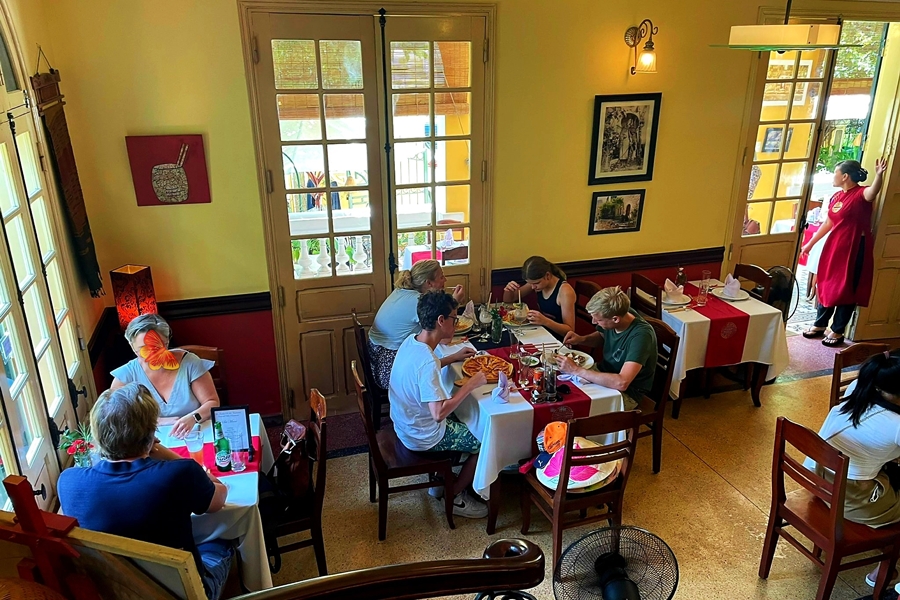 Interior Space of Le Jardin de La Carambole Restaurant in Hue with guests eating