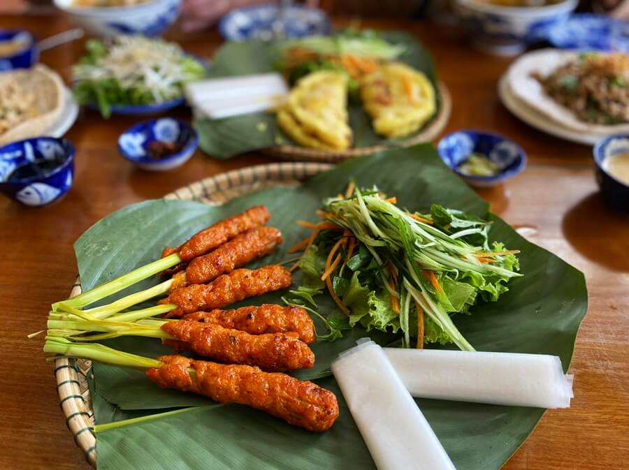 Nem Lui at Madam Thu Restaurant: One of the standout dishes in its menu, featuring grilled lemongrass pork served on fresh lemongrass stalks with vegetables and rice paper.