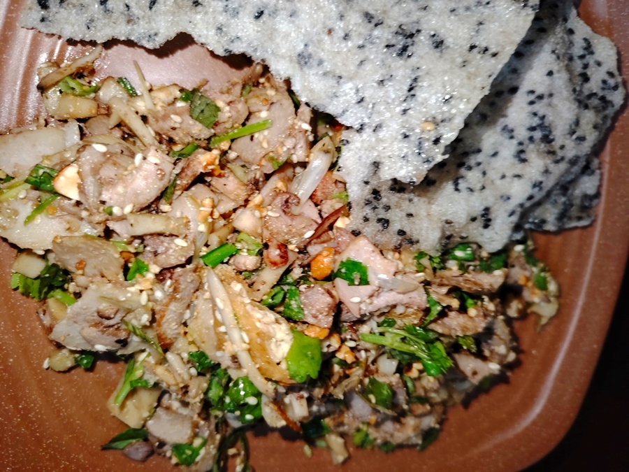 Hue specialty: thinly sliced figs mixed with mushrooms, roasted peanuts, and sesame, served with crispy grilled rice paper