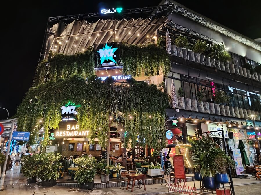 Green vines and trees cover the face of DMZ Restaurant in Hue City