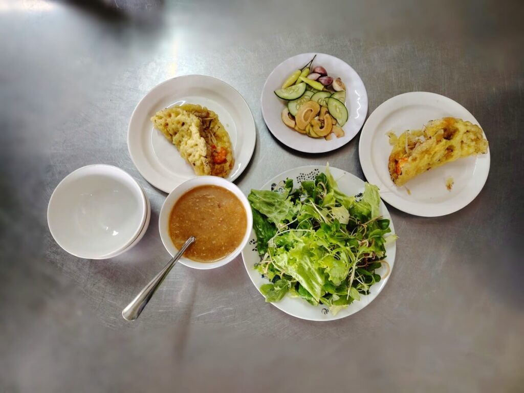banh khoai hue served with fresh herbs fig and dipping sauce