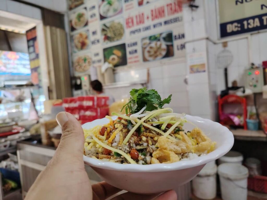 A bowl of com hen Hue serving a small restaurant